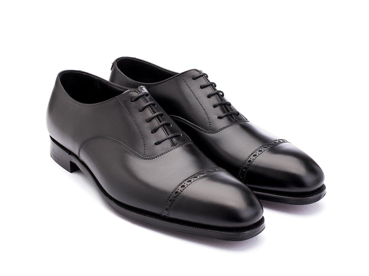 Front angle view of Crockett & Jones Belgrave quarter brogue oxford shoes in black calf