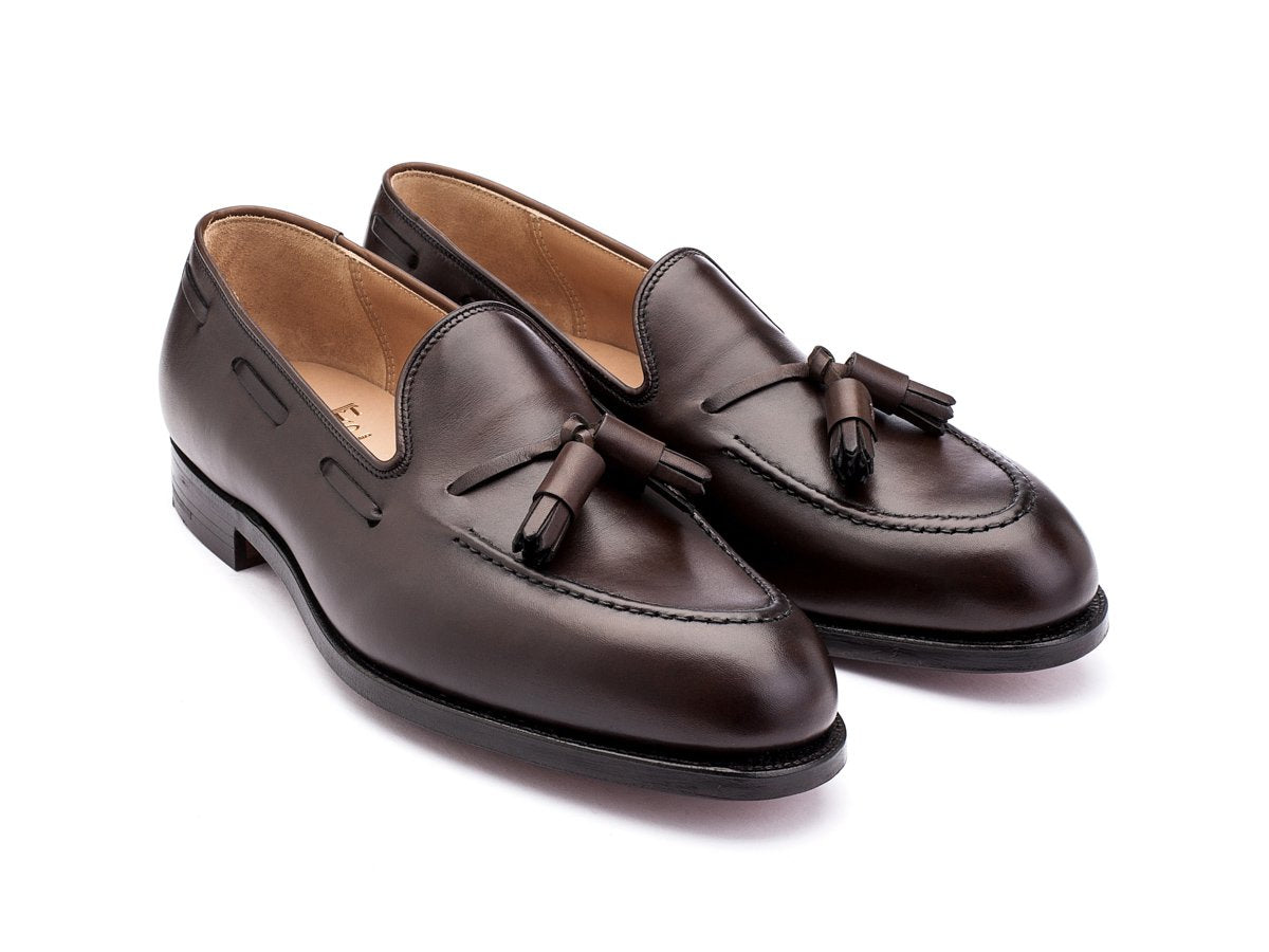 Front angle view of Crockett & Jones Cavendish tassel loafers in dark brown burnished calf
