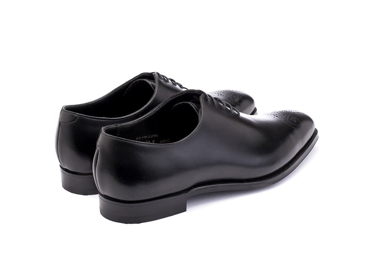 Back angle view of Crockett & Jones Weymouth wholecut medallion oxford shoes in black calf