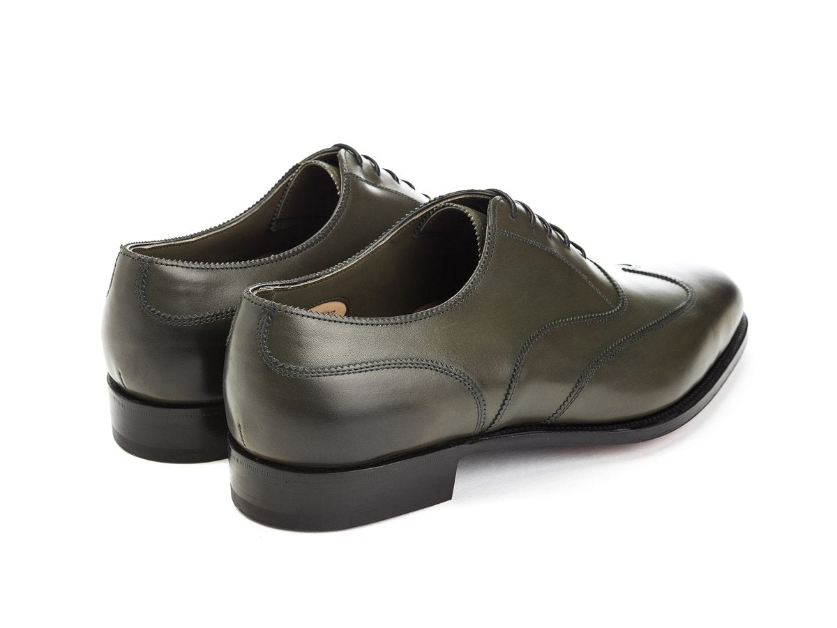 Back angle view of Edward Green Beaulieu austerity wingtip brogue oxford shoes in olive antique calf