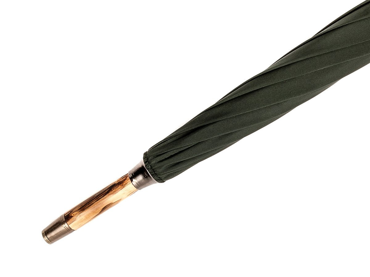 Tip end of solid congo Fox Umbrella with dark green canopy