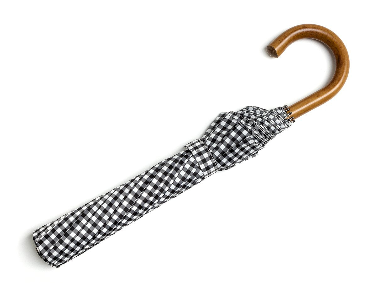 Full length view of malacca handle telescopic Fox Umbrella with black and white gingham canopy
