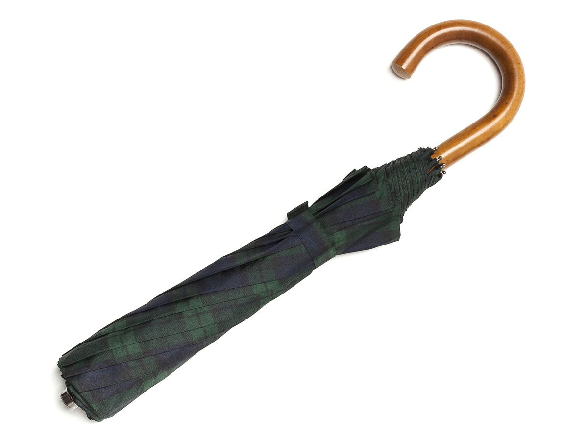 Full length view of malacca handle telescopic Fox Umbrella with black watch tartan canopy