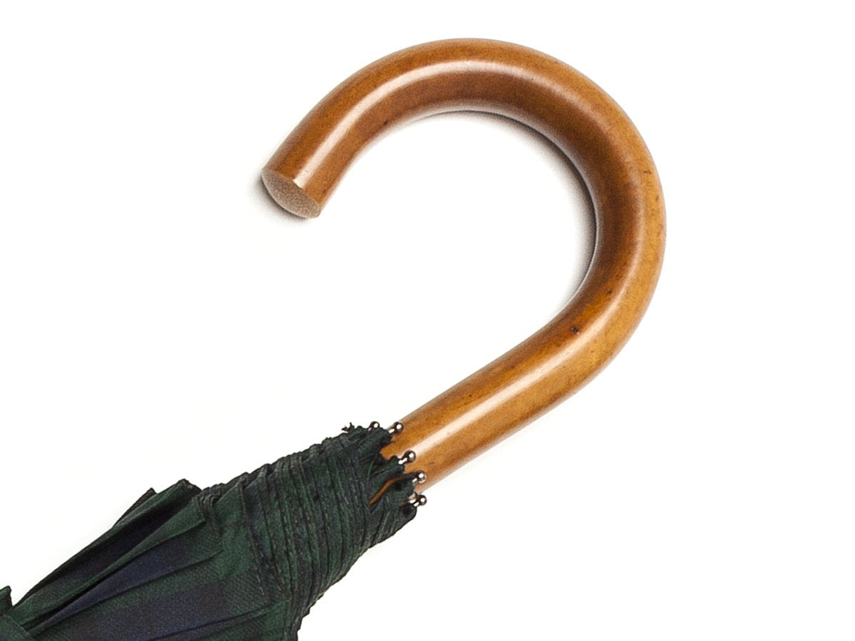 Malacca handle of telescopic Fox Umbrella with black watch tartan canopy