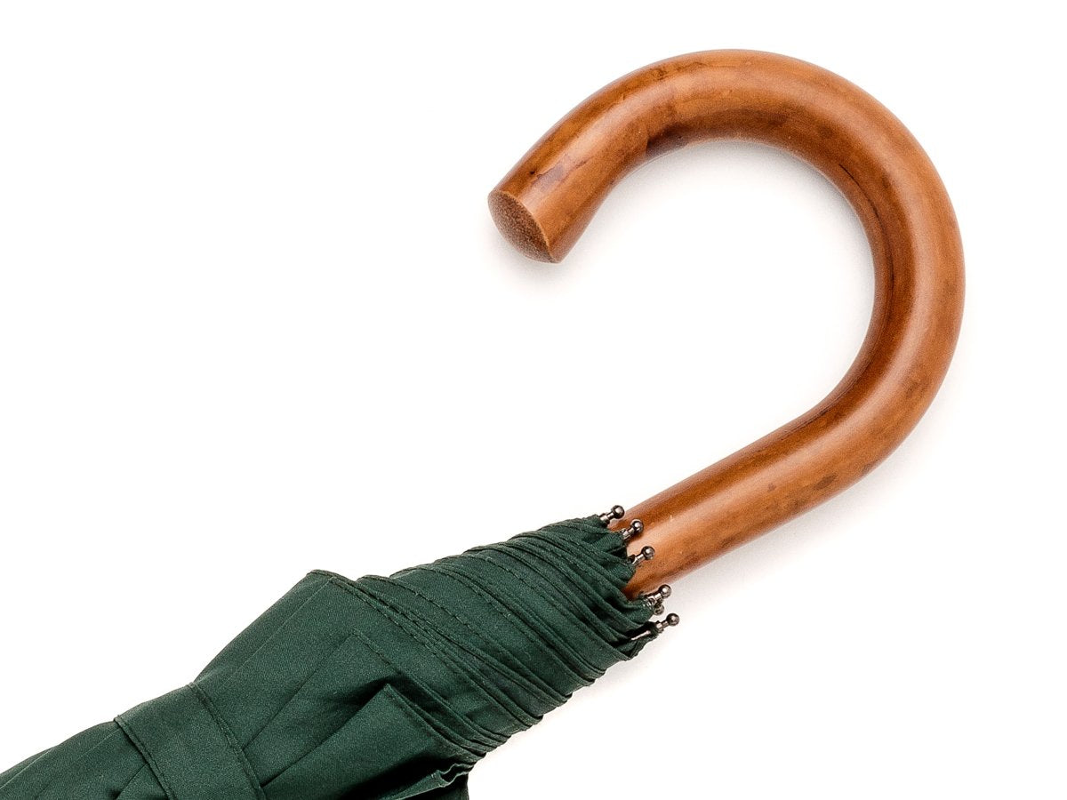 Malacca handle of telescopic Fox Umbrella with dark green canopy