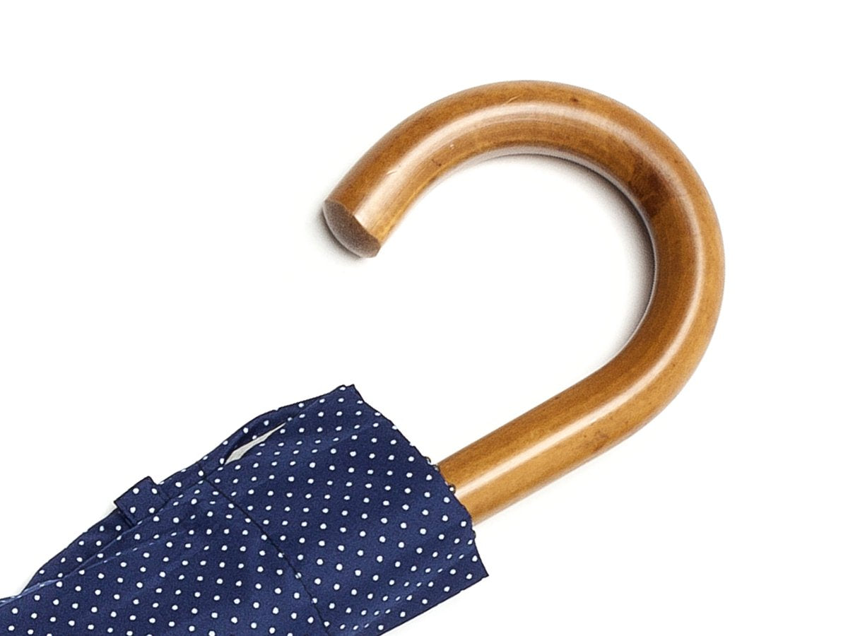 Malacca handle of telescopic Fox Umbrella with navy and white polka dot canopy cover