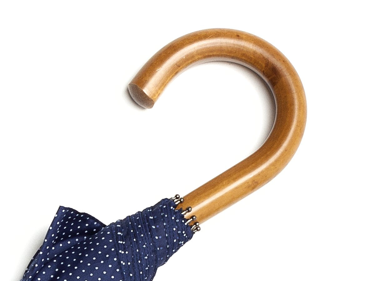Malacca handle of telescopic Fox Umbrella with navy and white polka dot canopy