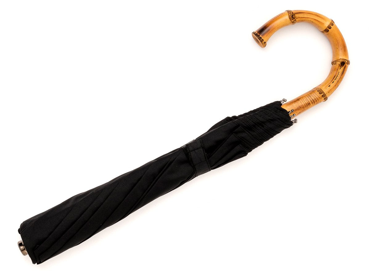 Full length view of whangee handle telescopic Fox Umbrella with black canopy