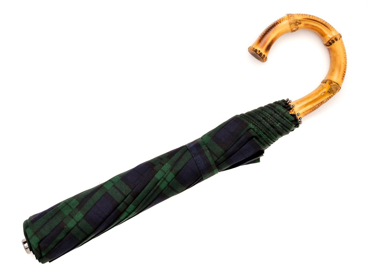 Full length view of whangee handle telescopic Fox Umbrella with black watch tartan canopy