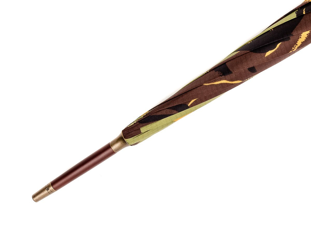Tip end of dark grain wood handle tube Fox Umbrella with camouflage canopy