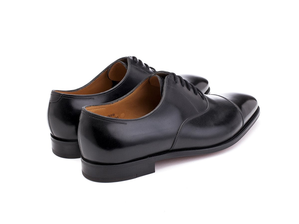 Back angle view of John Lobb City II plain captoe oxford shoes in black calf