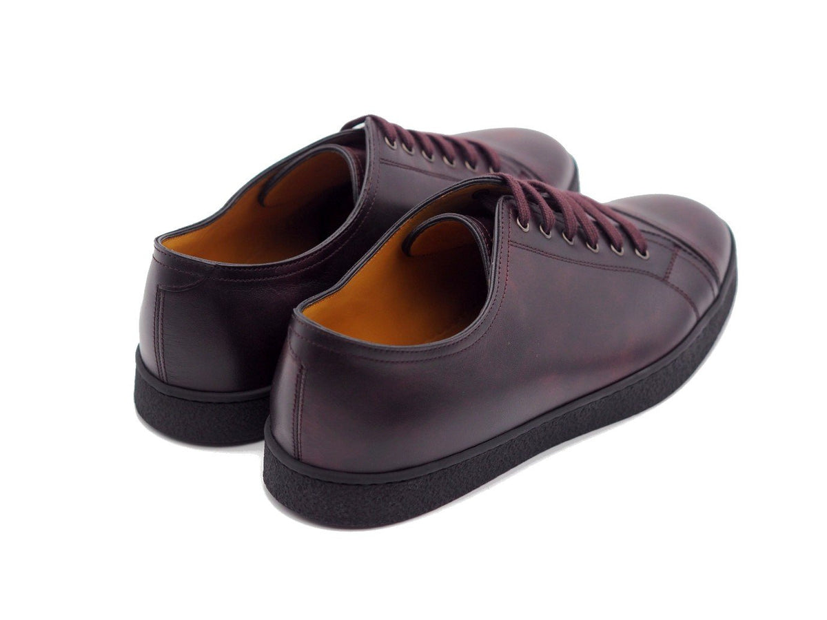 Back angle view of John Lobb Levah classic tennis sneakers in plum museum calf