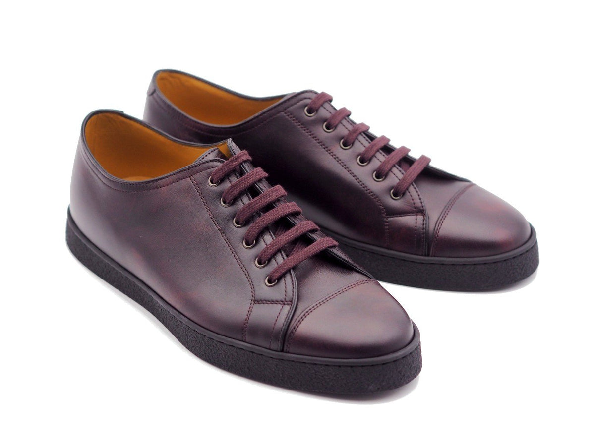 Front angle view of John Lobb Levah classic tennis sneakers in plum museum calf