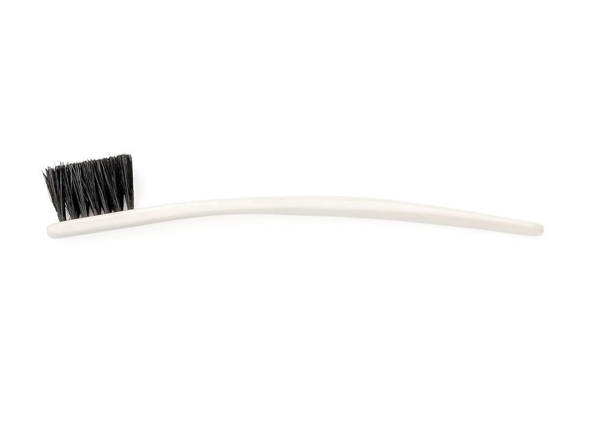 Side view of toothbrush sized bone shoe polishing brush with black bristles