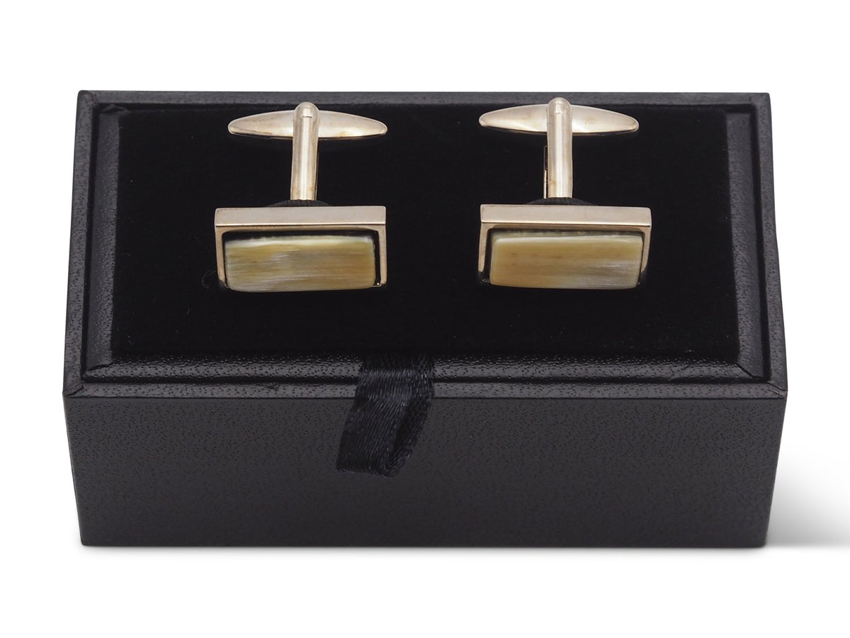Front view of rectangle shaped horn cufflinks sitting on box