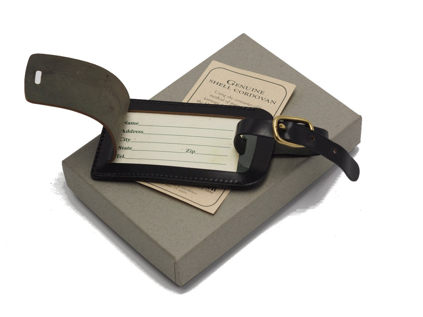 Opened Alden luggage tag in black shell cordovan on top of box
