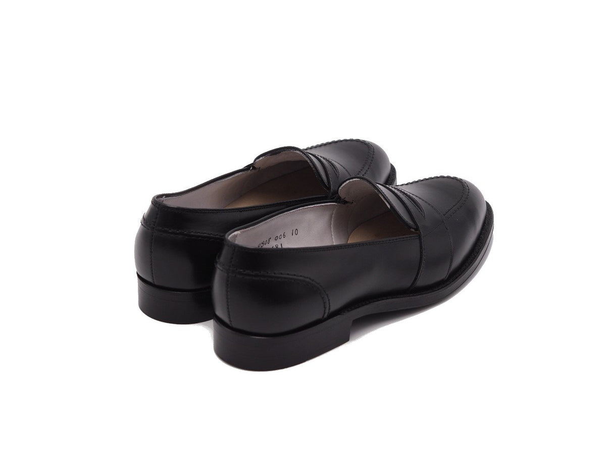 Back angle view of Alden full strap penny loafer in black calf