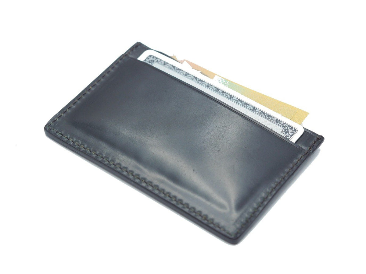 Back view of filled Alden slim credit card case in black shell cordovan