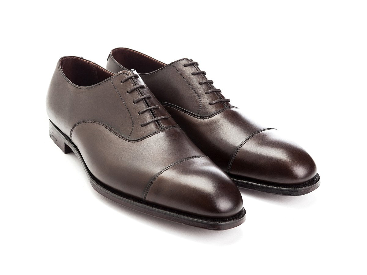 Front angle view of Crockett & Jones Audley plain captoe oxford shoes in dark brown antique calf