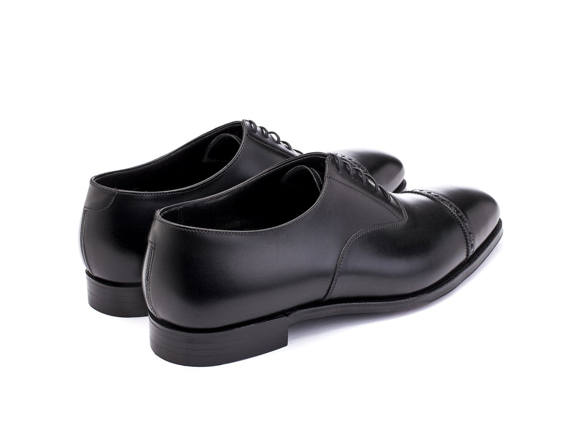 Back angle view of Crockett & Jones Belgrave quarter brogue oxford shoes in black calf