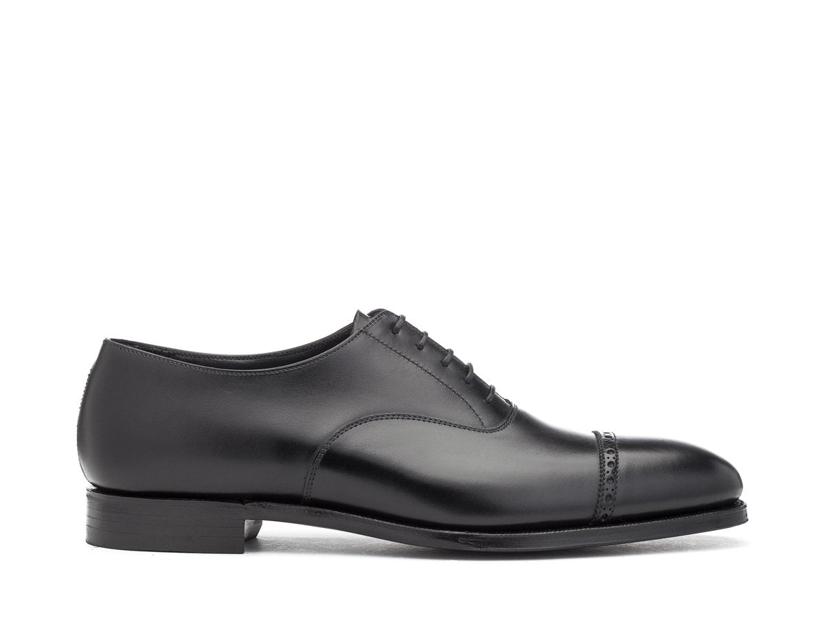 Side view of Crockett & Jones Belgrave quarter brogue oxford shoes in black calf