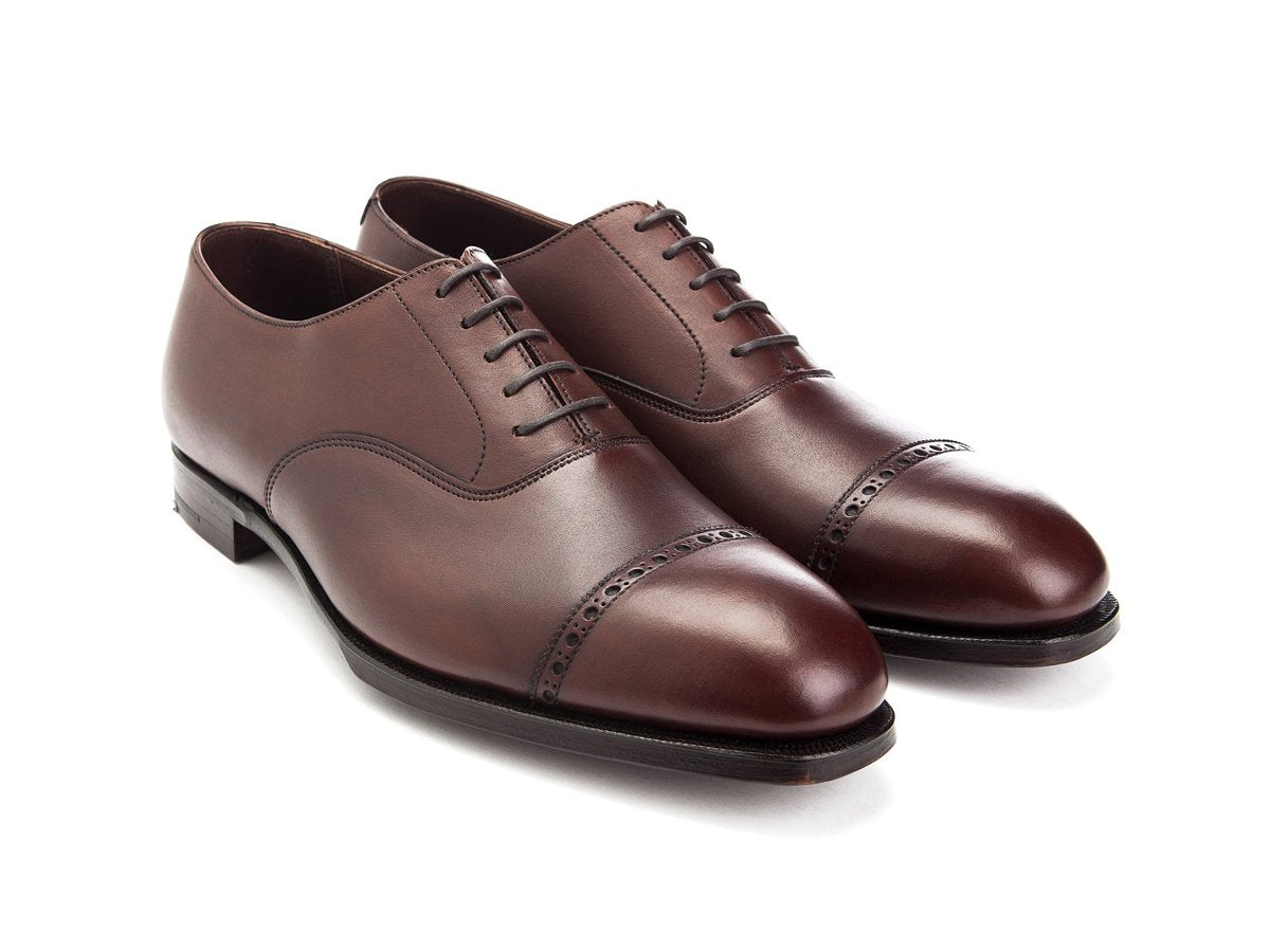 Front angle view of Crockett & Jones Belgrave quarter brogue oxford shoes in chestnut antique calf