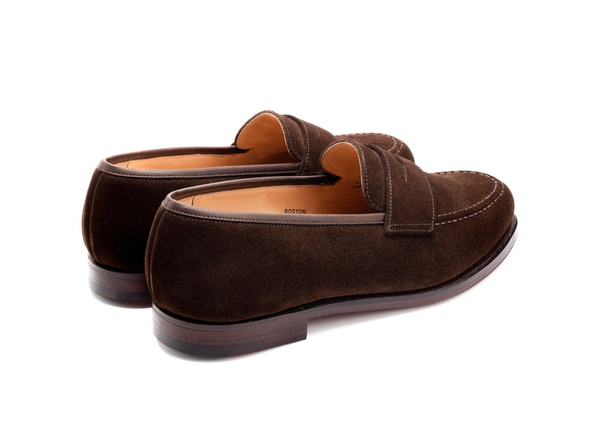 Back angle view of Crockett & Jones Boston penny loafers in dark brown suede