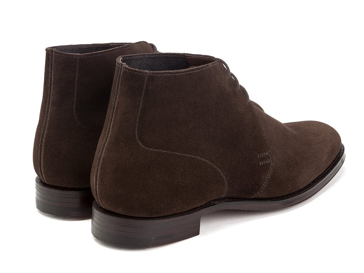 Back angle view of Crockett & Jones Chukka boots in dark brown suede