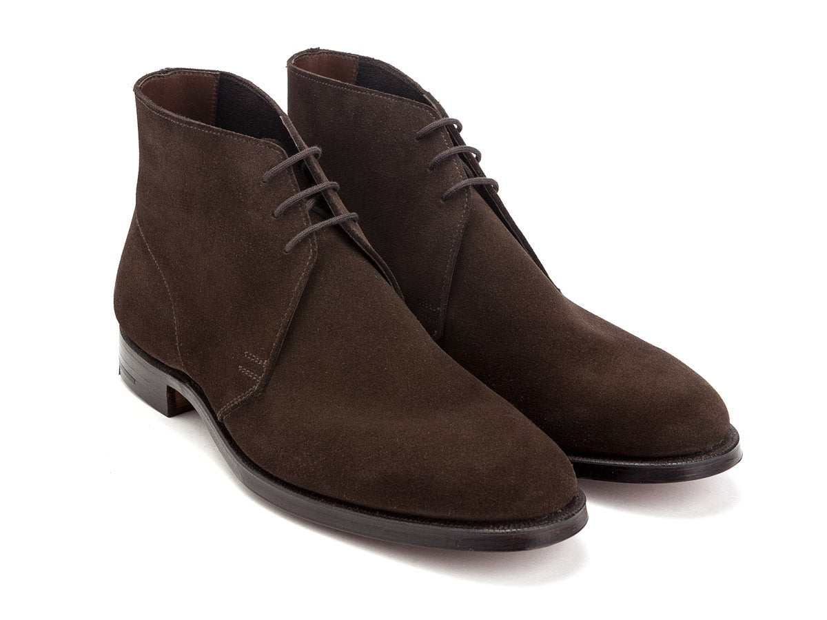 Front angle view of Crockett & Jones Chukka boots in dark brown suede