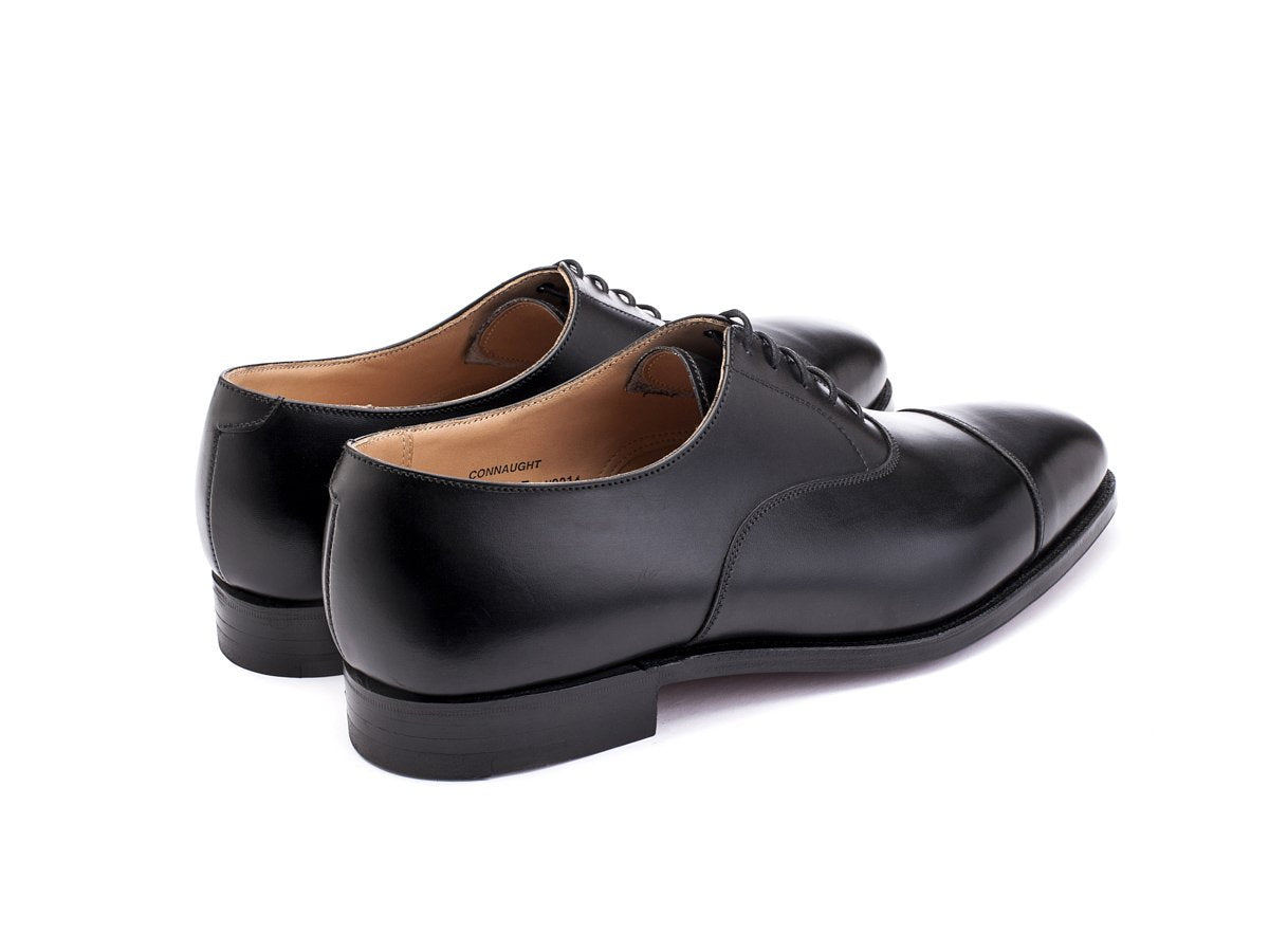 Back angle view of Crockett & Jones Connaught plain captoe oxford shoes in black calf
