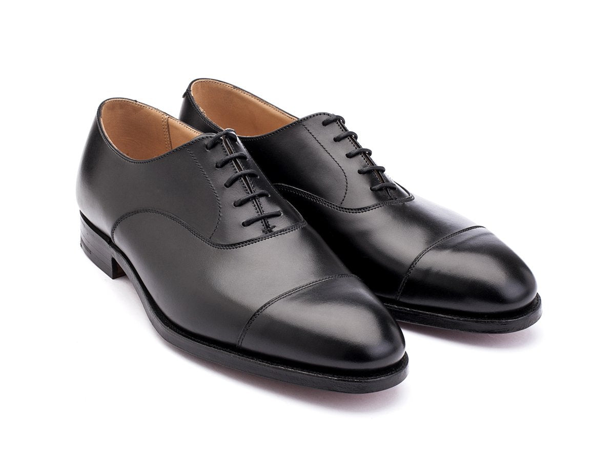 Front angle view of Crockett & Jones Connaught plain captoe oxford shoes in black calf