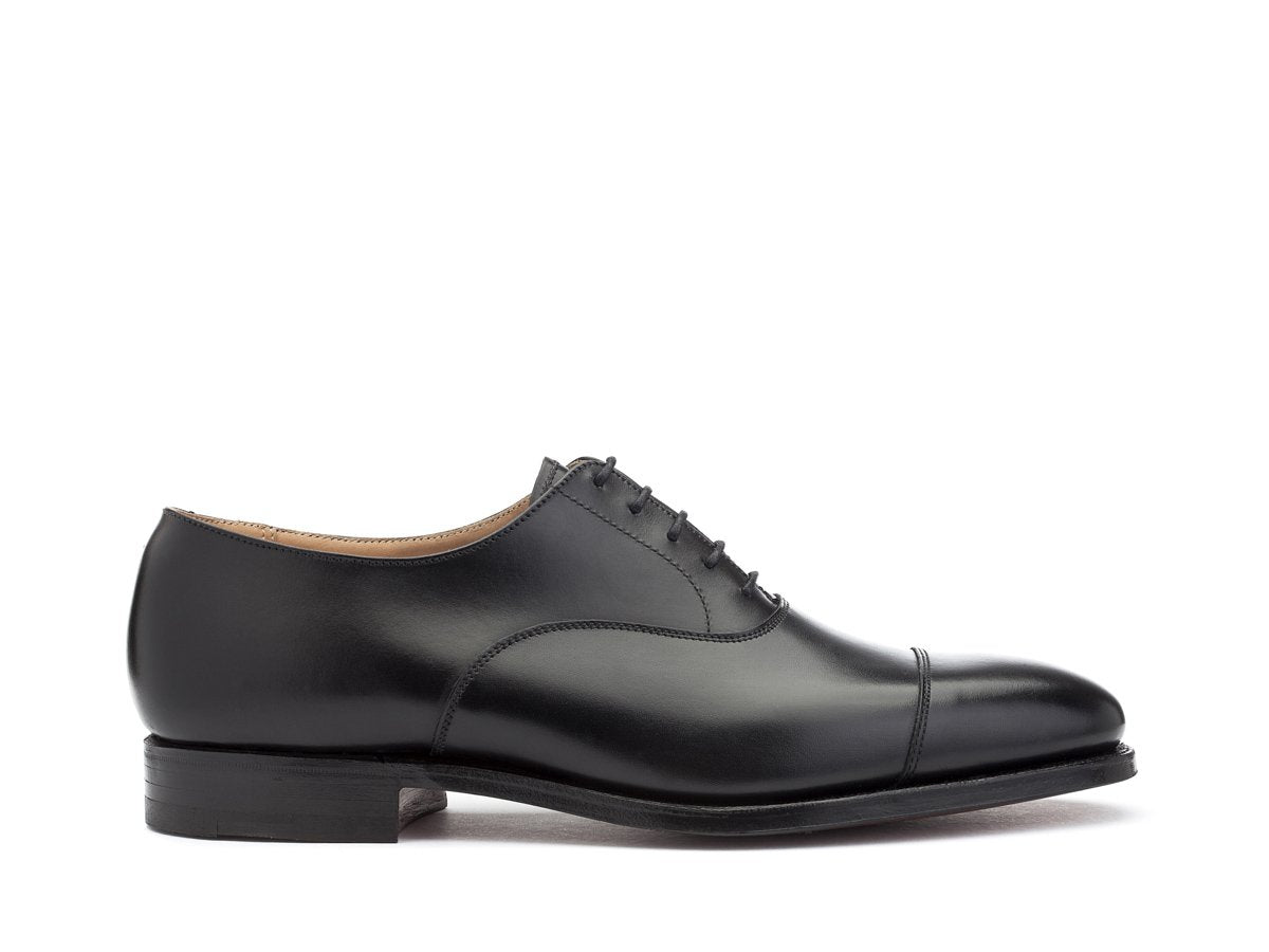 Side view of Crockett & Jones Connaught plain captoe oxford shoes in black calf