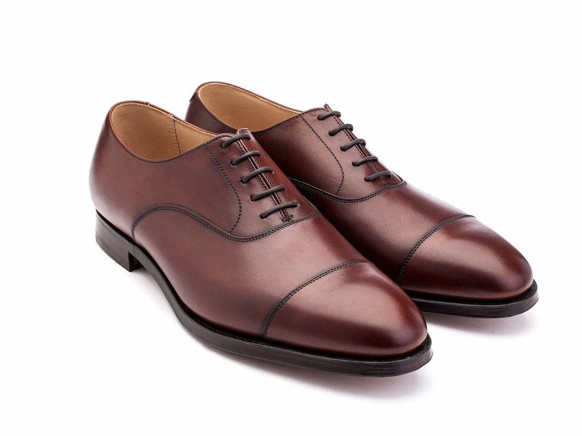 Front angle view of F width Crockett & Jones Connaught plain captoe oxford shoes in chestnut burnished calf