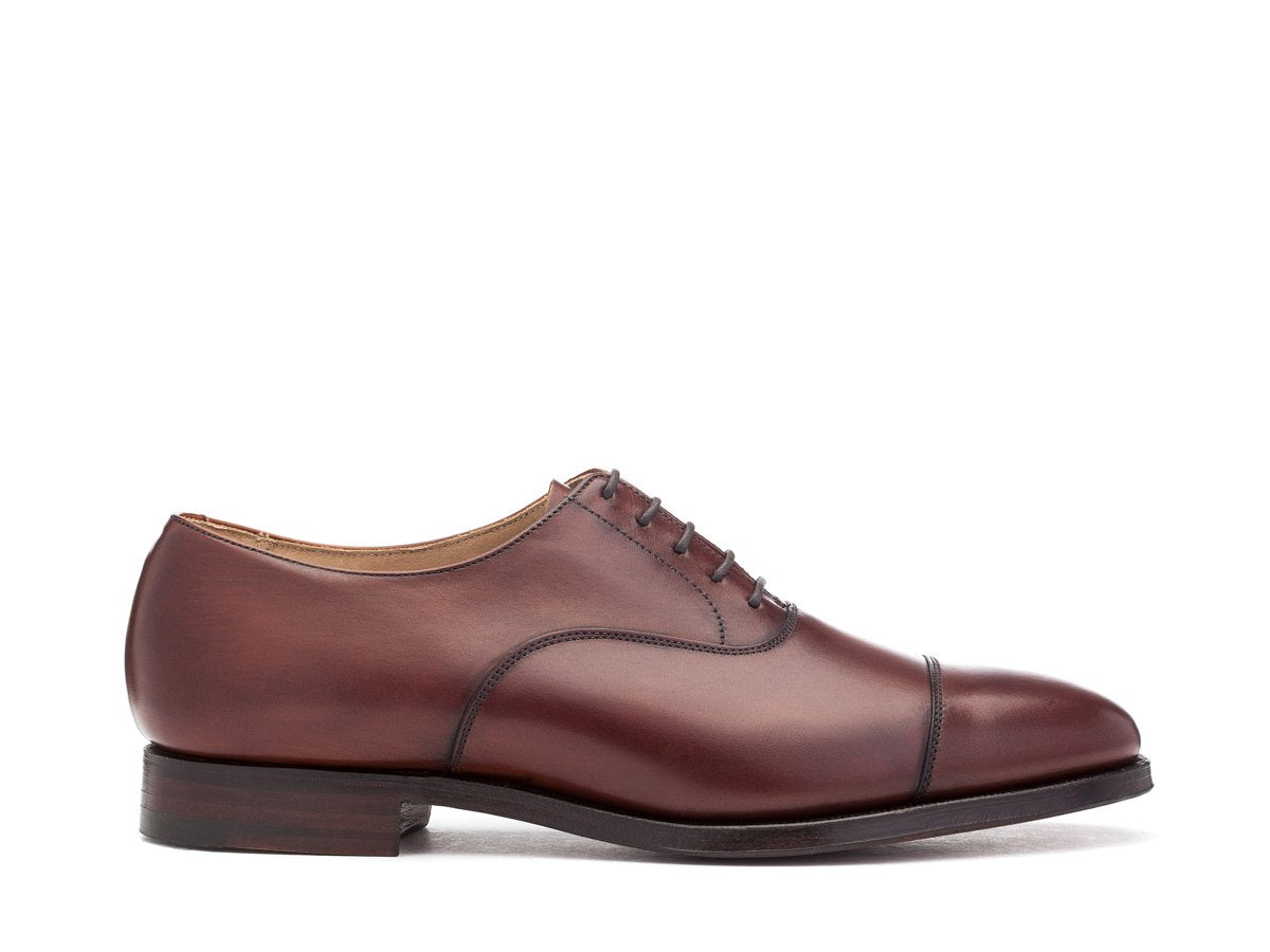 Side view of F width Crockett & Jones Connaught plain captoe oxford shoes in chestnut burnished calf