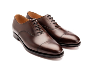 Front angle view of Crockett & Jones Connaught plain captoe oxford shoes in dark brown burnished calf