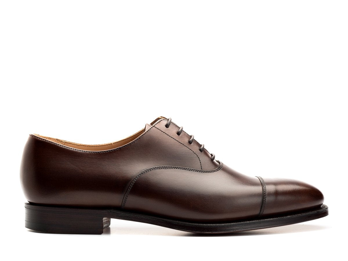 Side view of Crockett & Jones Connaught plain captoe oxford shoes in dark brown burnished calf