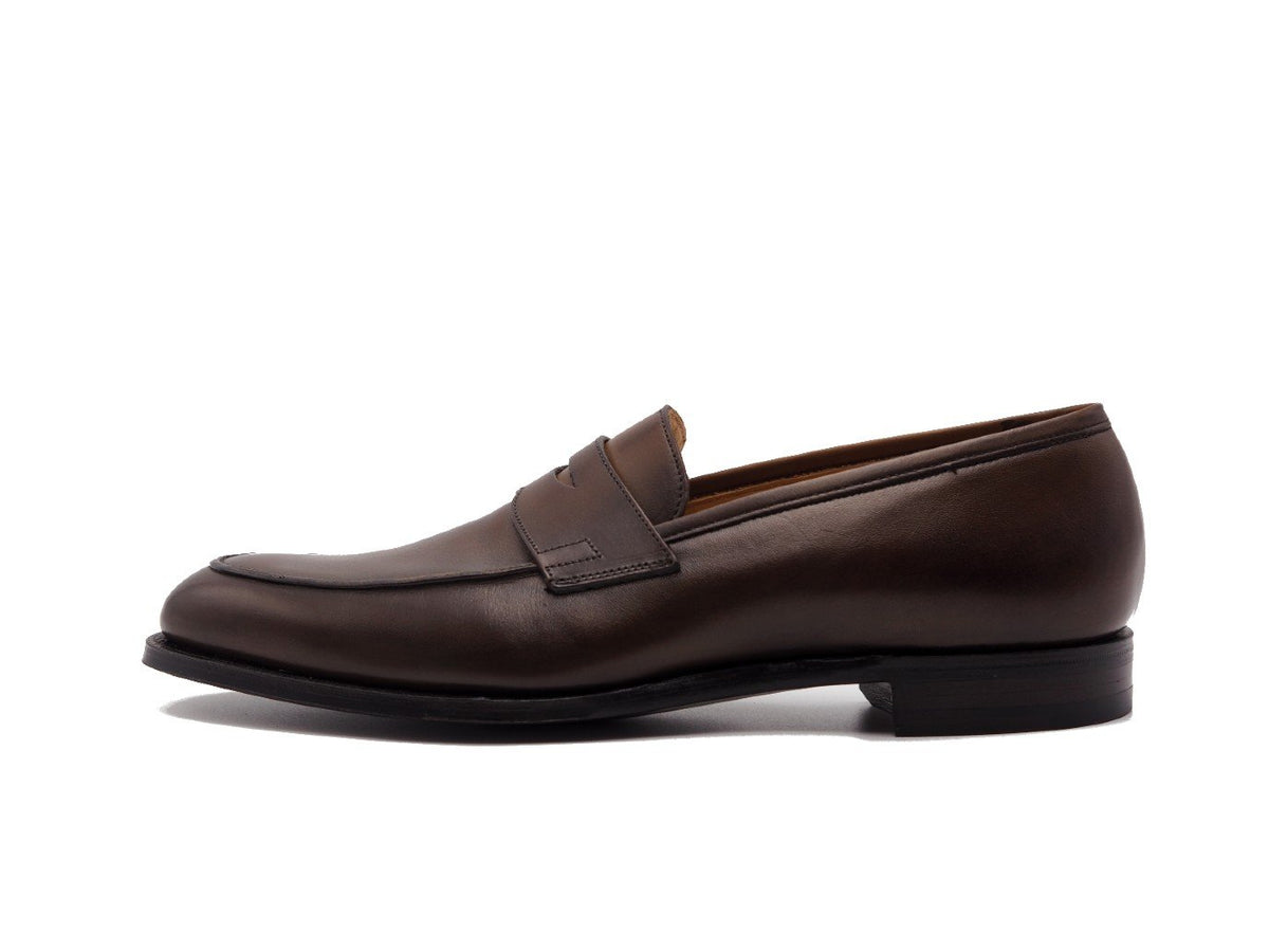 Side view of Crockett & Jones Crawford penny loafers in dark brown antique calf