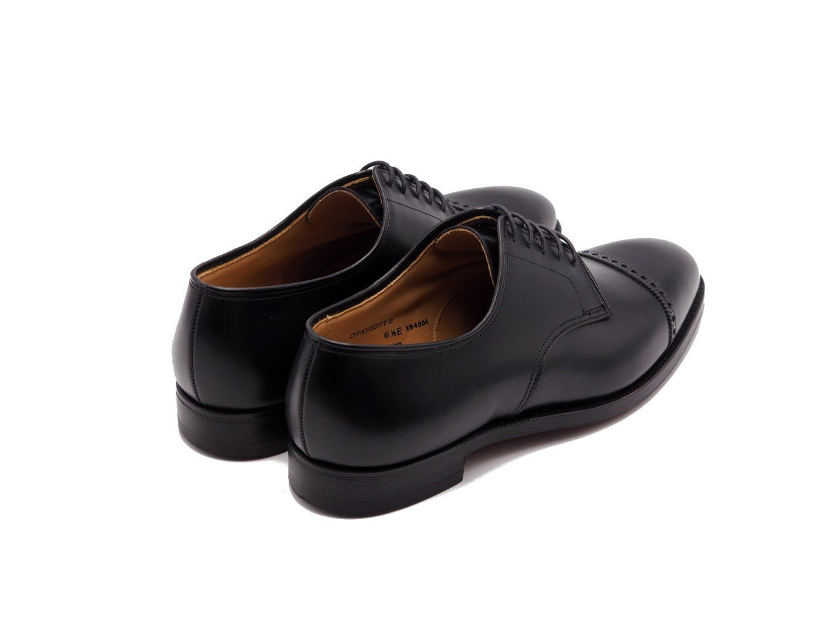 Back angle view of Crockett & Jones Draycott 2 quarter brogue derby shoes in black calf