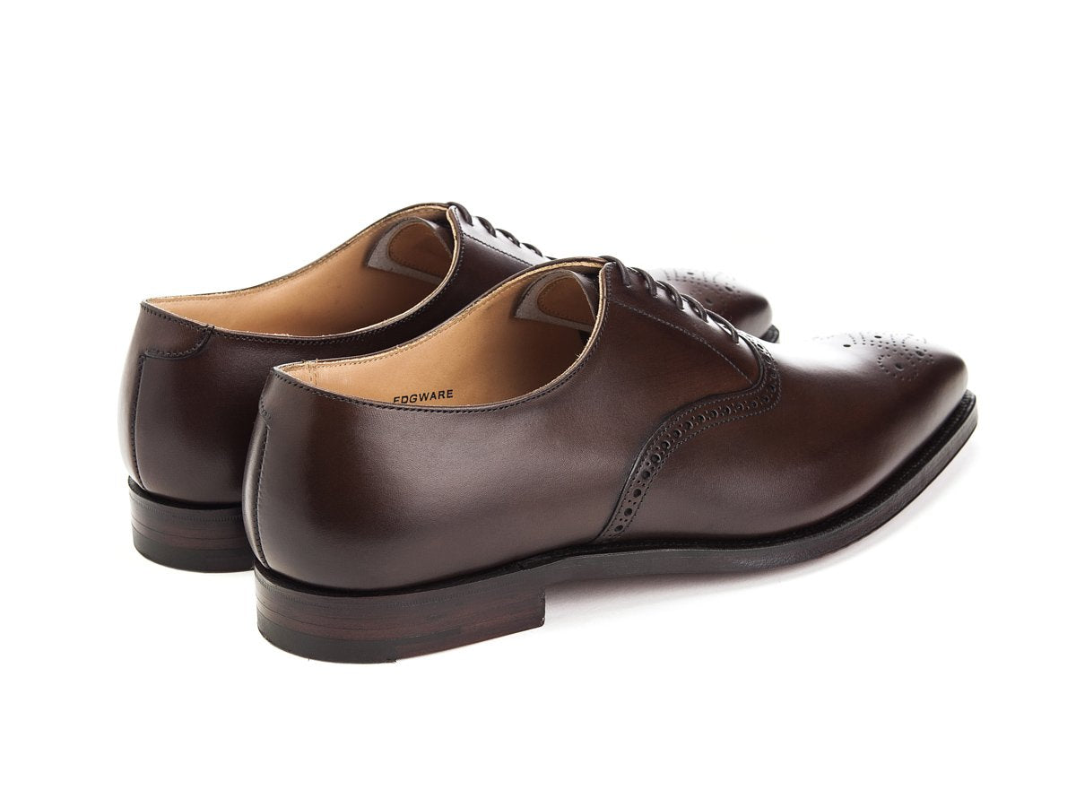 Back angle view of Crockett & Jones Edgware medallion brogue oxford shoes in dark brown burnished calf