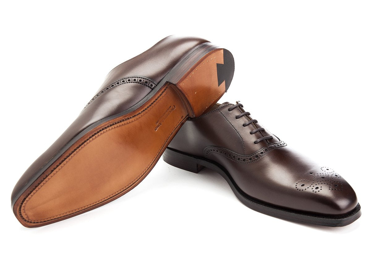 Leather sole of Crockett & Jones Edgware medallion brogue oxford shoes in dark brown burnished calf