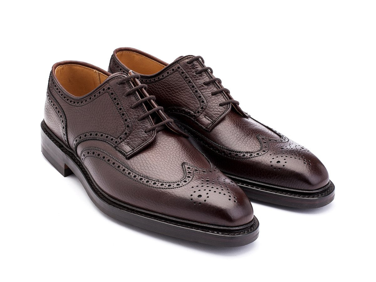 Front angle view of Crockett & Jones Exmoor wingtip full brogue derby shoes in dark brown country calf