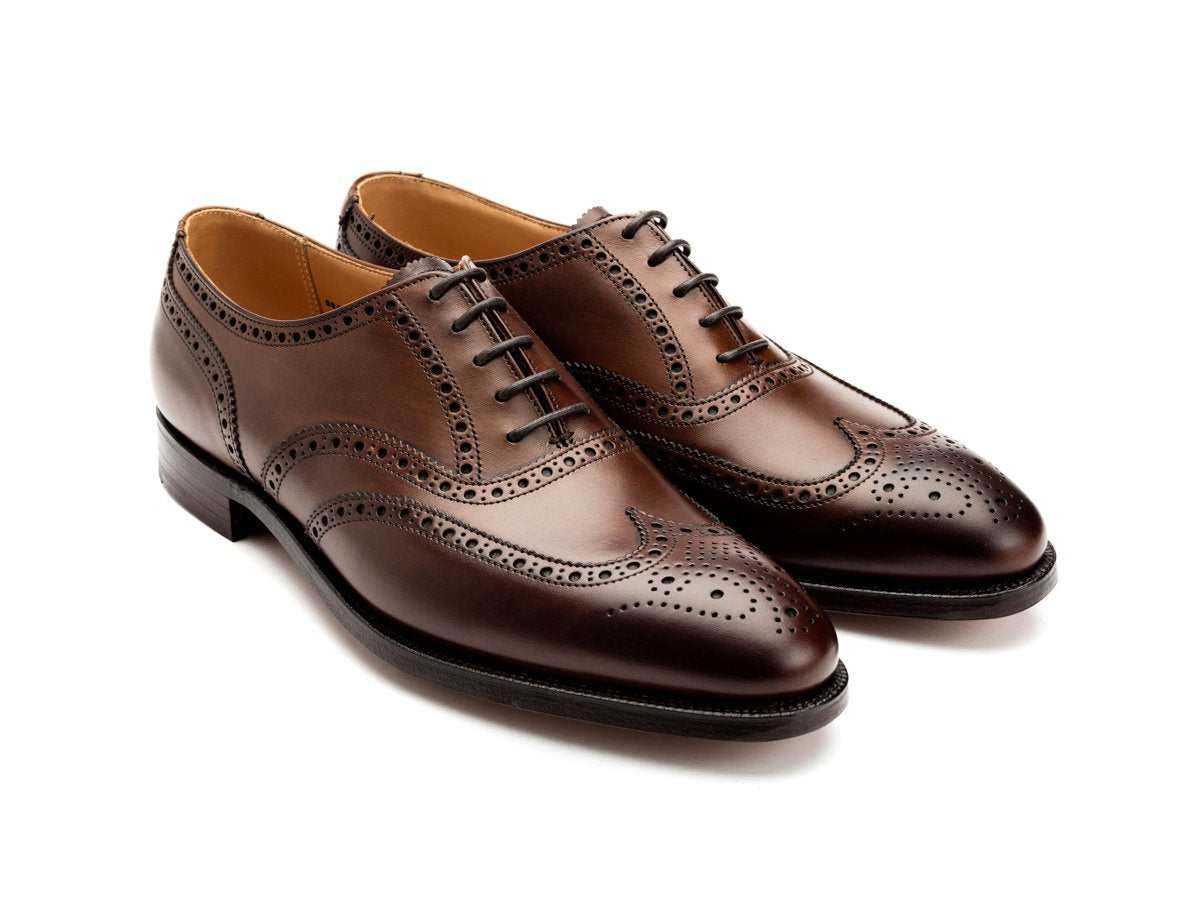 Front angle view of Crockett & Jones Finsbury wingtip full brogue oxford shoes in dark brown burnished calf