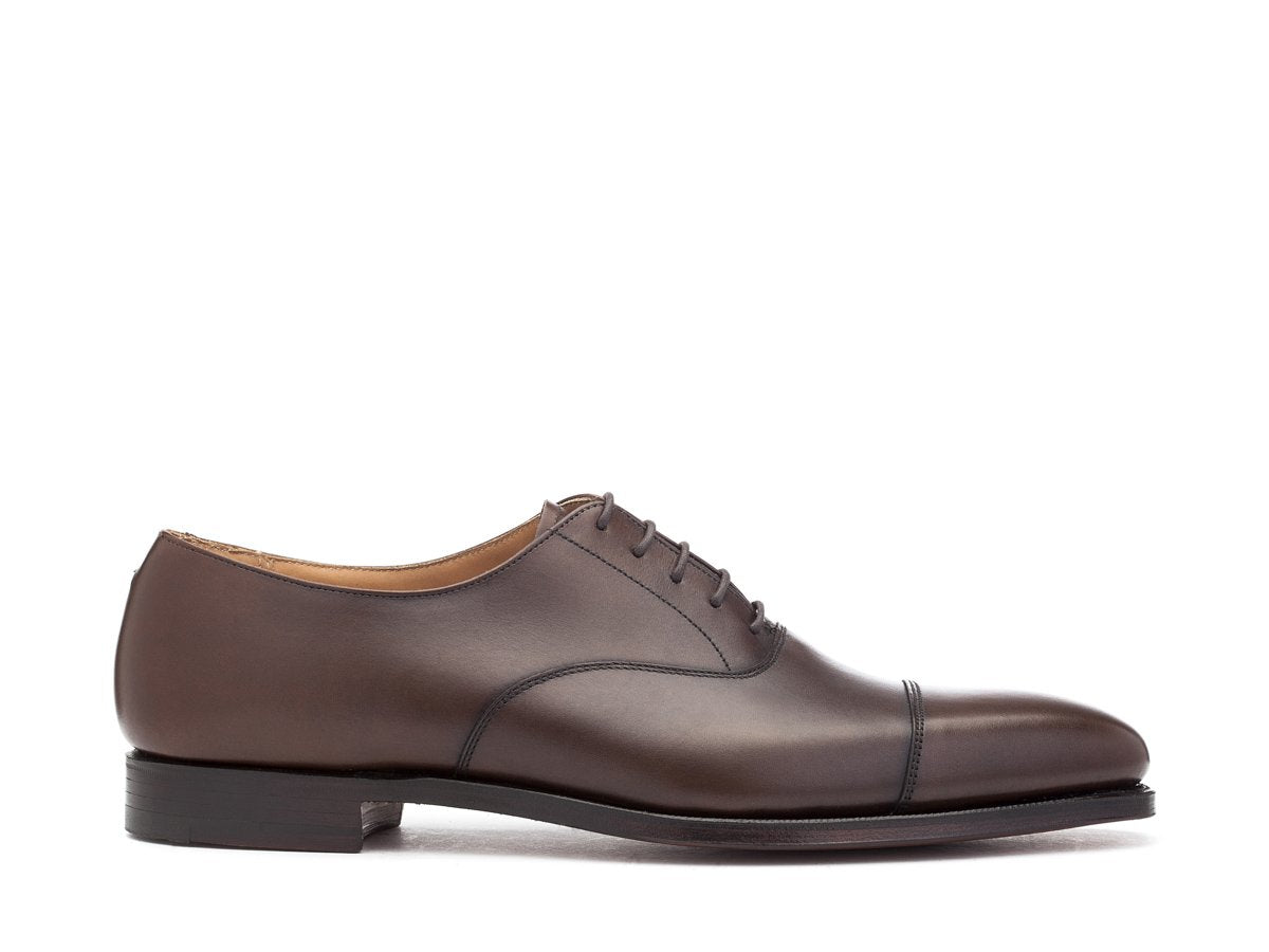 Side view of Crockett & Jones Hallam plain captoe oxford shoes in dark brown burnished calf