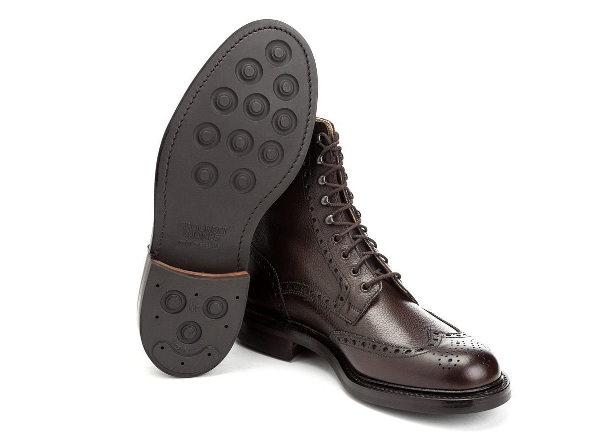 Dainite rubber sole of Crockett & Jones Islay wingtip brogue derby boots in dark brown scotch grain calf