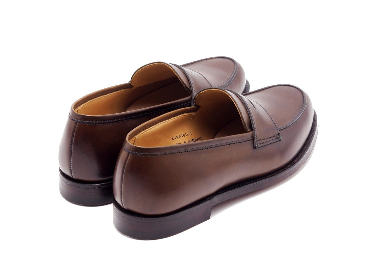 Back angle view of Crockett & Jones Kirribilli penny loafers in dark brown burnished calf