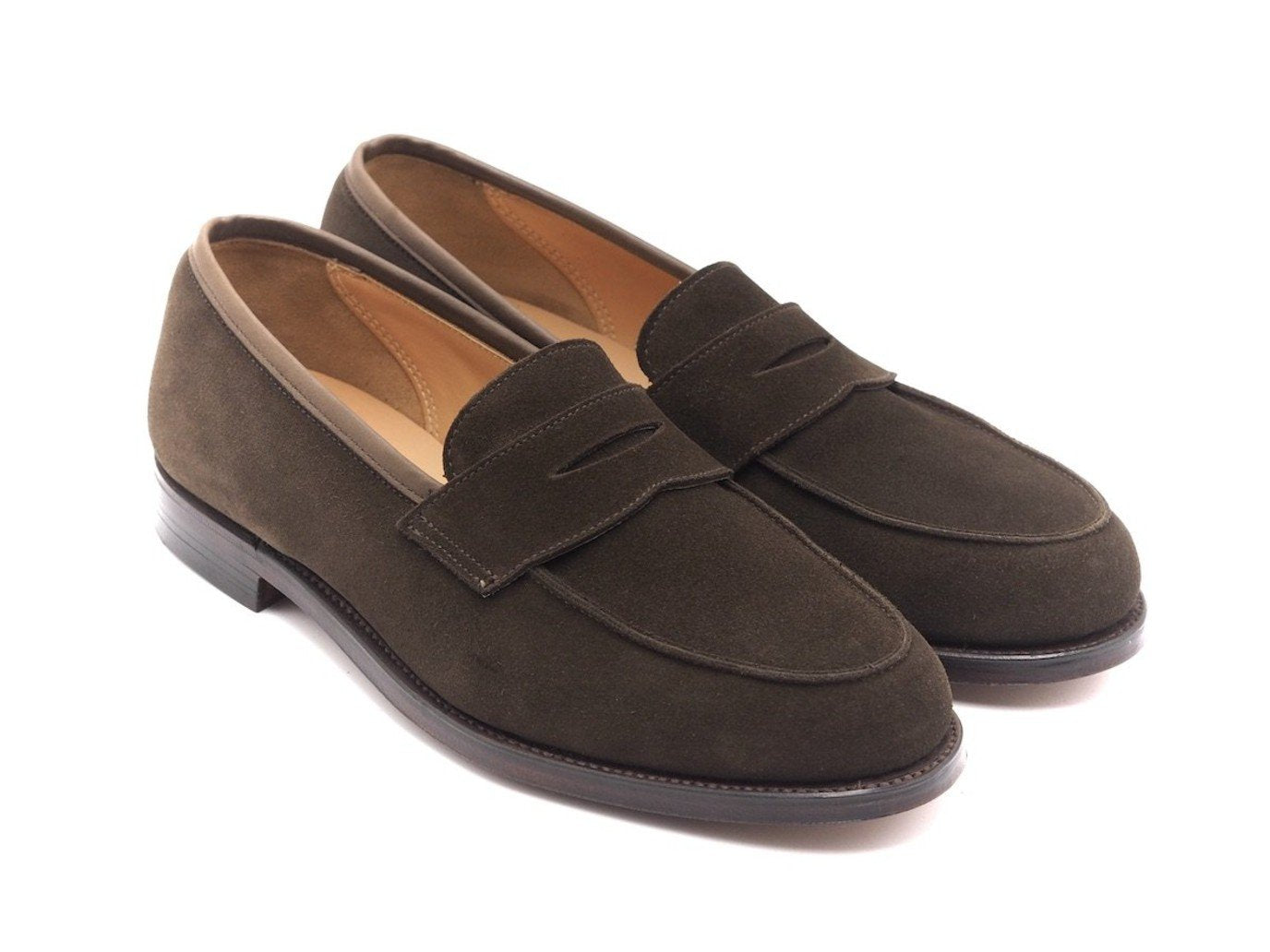 Front angle view of Crockett & Jones Kirribilli penny loafers in dark brown suede
