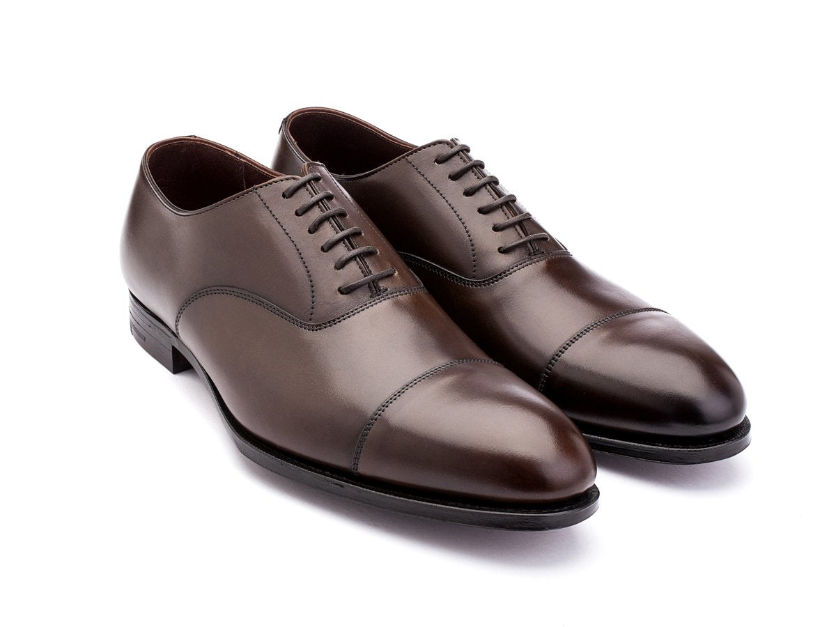Front angle view of Crockett & Jones Lonsdale plain captoe oxford shoes in dark brown antique calf