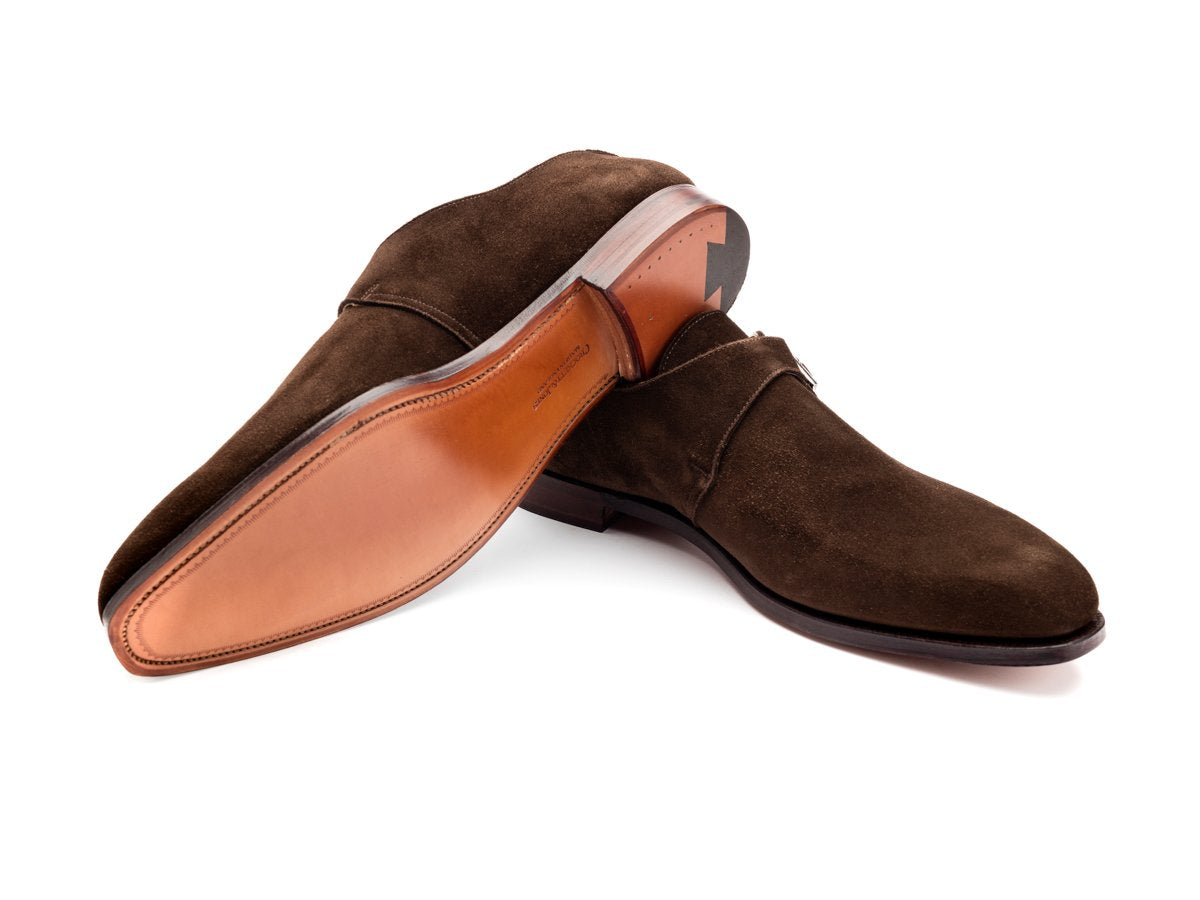 Leather sole of Crockett & Jones Monkton plain toe single monk strap shoes in dark brown suede