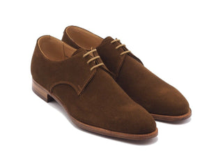 Front angle view of Crockett & Jones Newquay plain toe derby shoes in snuff suede