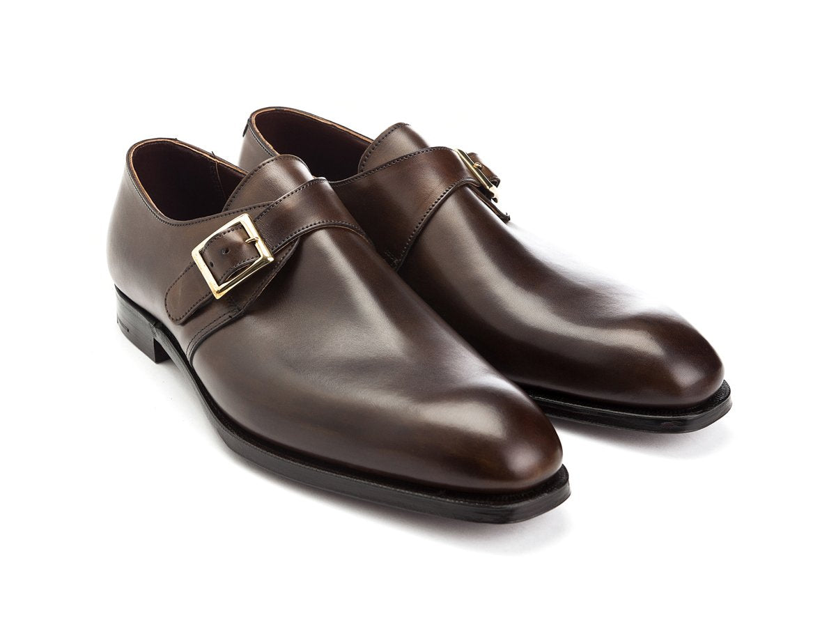 Front angle view of Crockett & Jones Savile plain toe single monk strap shoes in dark brown antique calf
